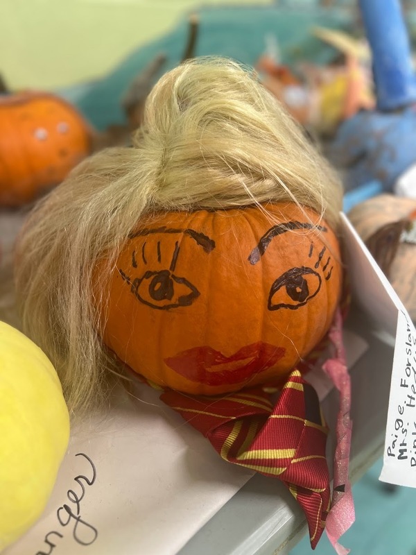 Pumpkin with a face and a wig